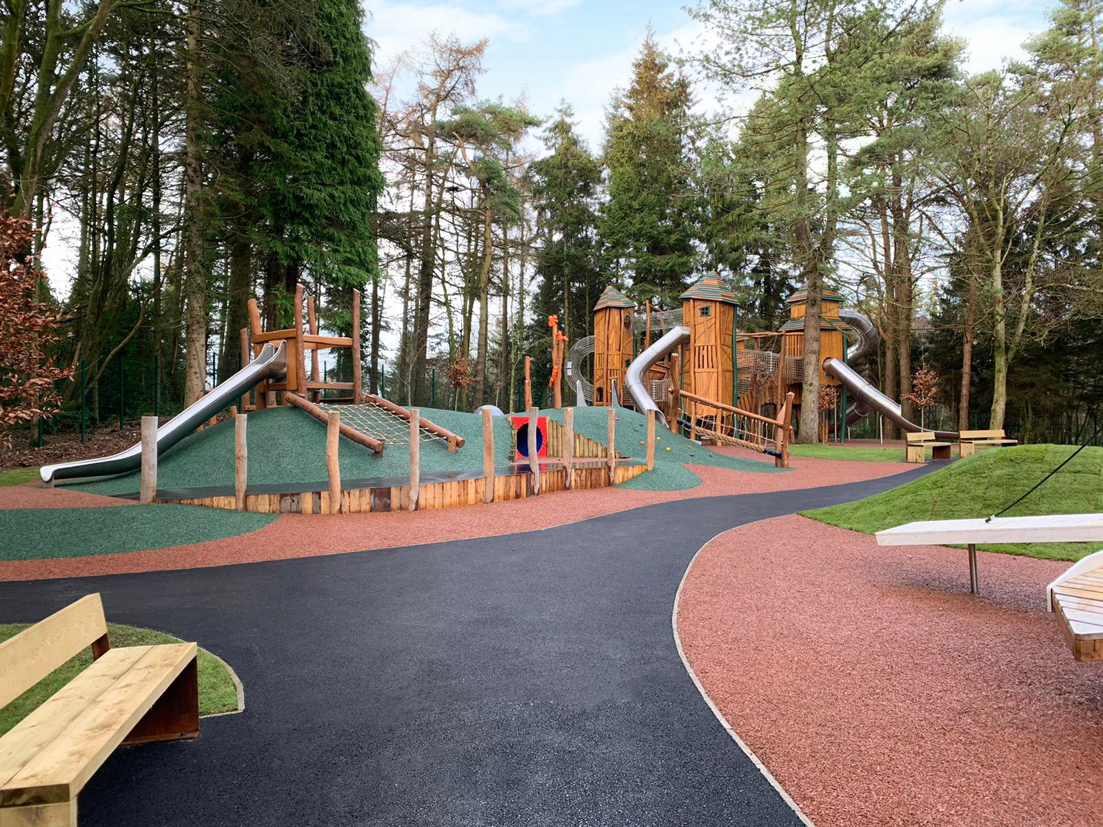Pathway leading to multi tower play unit and trail mound