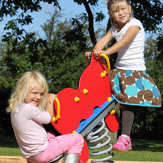 Two girls on butterfly spring seesaw