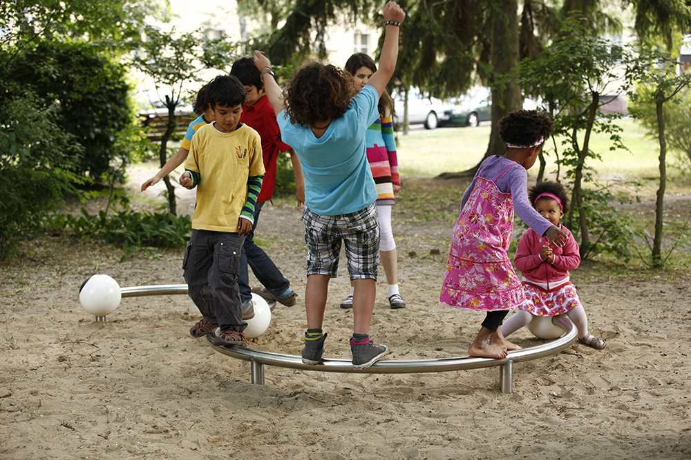 Children playing on stainless steel curved balance beam