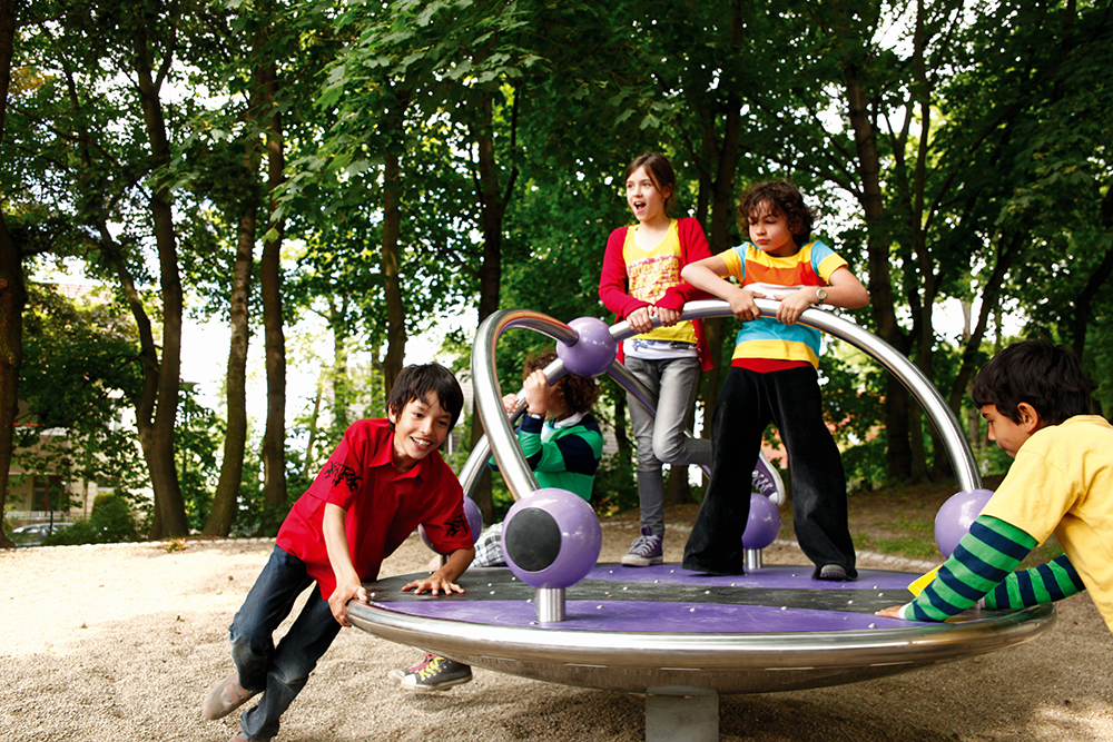 Children playing on purple roundabout