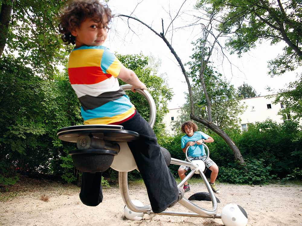 Children playing on steel seesaw