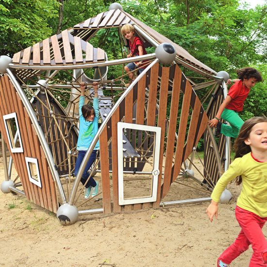 Children playing on bamboo play structure