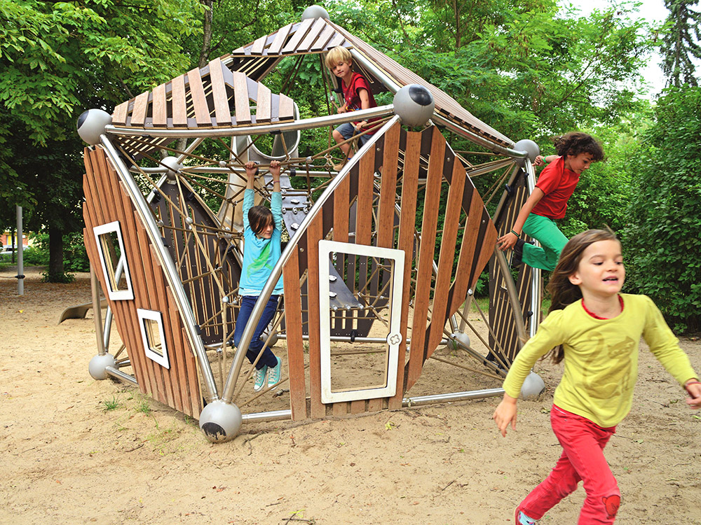 Children playing on bamboo play structure