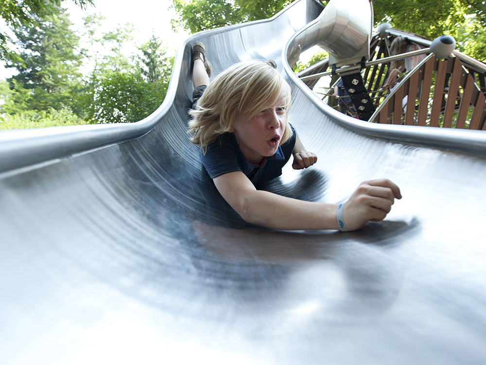 Little boy going down slide
