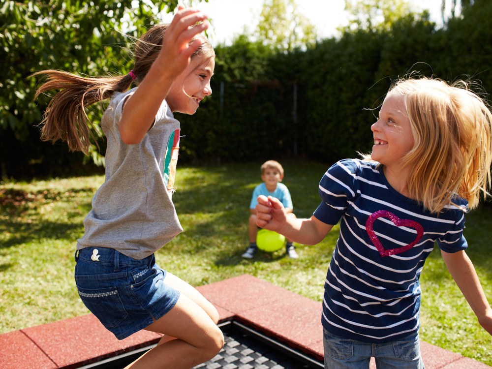 Children playing on kids tramp trampoline