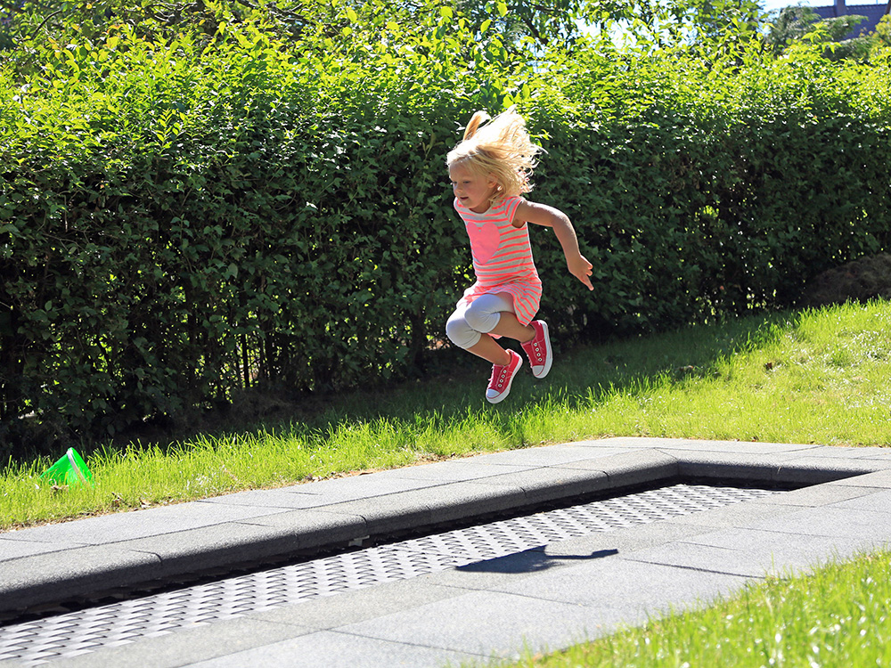 Girl playing on kids tramp track trampoline