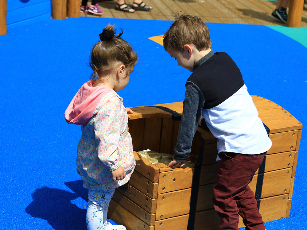 children playing with timber treasure chest