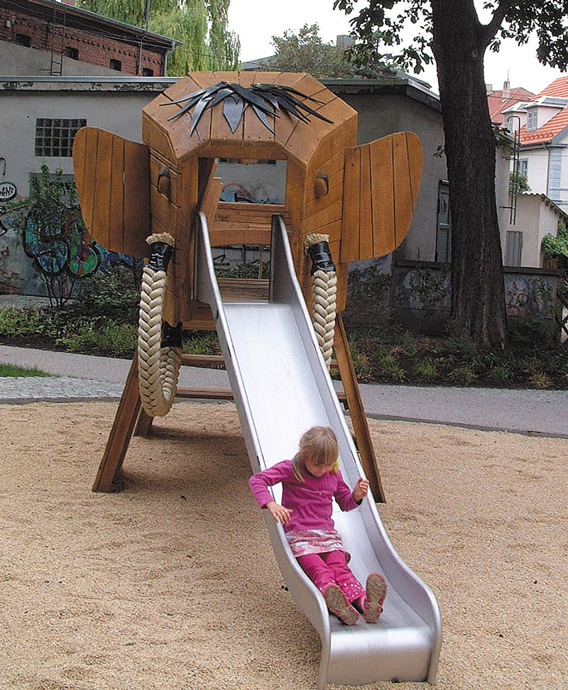 Girl on elephant playground climbing frame slide