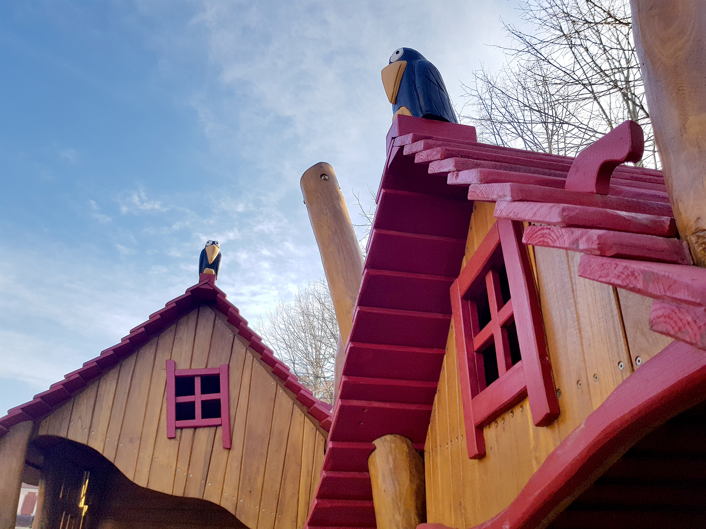 Timber playhouse roofs and bird carvings